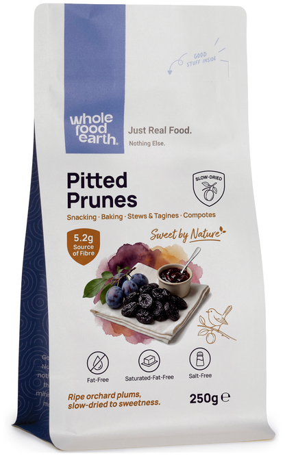 Whole Food Earth medium-sized pitted prunes, dried fruit with smooth, dark, wrinkled surface, ready for snacking or baking.