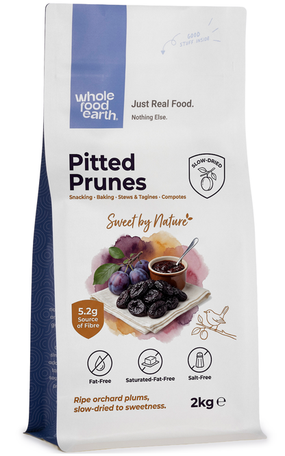 Dried medium-sized pitted prunes from Whole Food Earth, showcasing dark, wrinkled dried fruit with smooth pits visible.