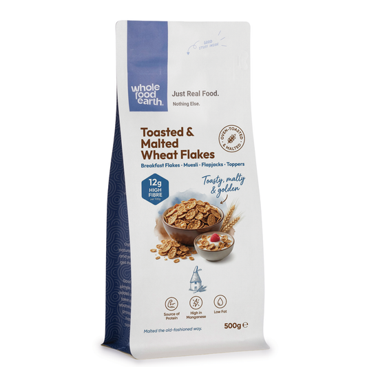 Whole Food Earth toasted and malted wheat flakes cereal in a bowl, close-up shot showing crispy, golden-brown flakes