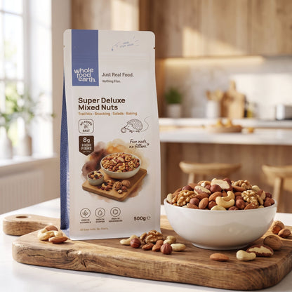 Mixed nuts from Whole Food Earth Super Deluxe Nuts package, featuring a variety of almonds, cashews, and walnuts in a clear container.
