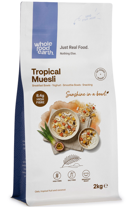 Whole Food Earth Tropical Muesli cereal with flakes, dried fruit, and nuts in a colorful bowl.