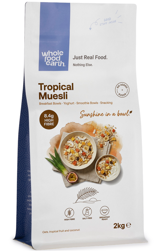 Whole Food Earth Tropical Muesli cereal with flakes, dried fruit, and nuts in a colorful bowl.