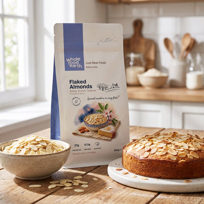 Whole Food Earth flaked almonds in a bowl, showing their thin, crunchy texture, perfect for baking or snacking.