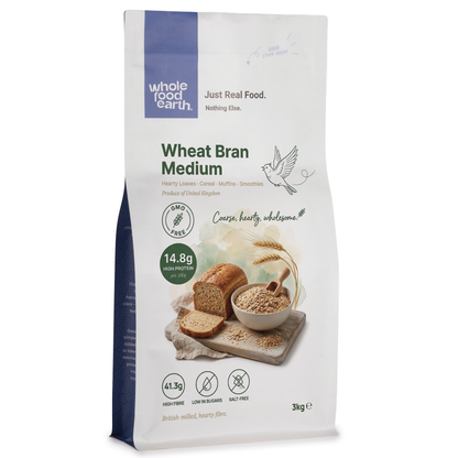 Whole Food Earth wheat bran medium cereal in a clear bowl, showing the light brown, textured bran flakes on a white background.