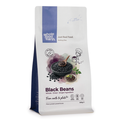 Whole Food Earth black beans, dried beans and pulses in a close-up image showing their smooth black surface and plump shape.