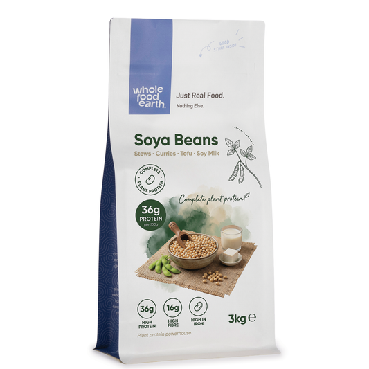 Whole Food Earth soy beans, organic beans and pulses, small beige soy beans in a clear bowl on a white background.