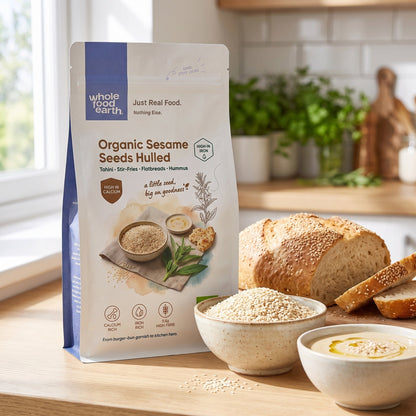 Hulled sesame seeds from Whole Food Earth, close-up of small, light tan seeds in a bowl for cooking or baking.