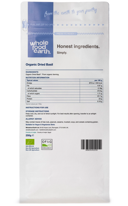 Fresh organic basil herb from Whole Food Earth, showing vibrant green leaves in a clear container.