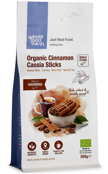 Whole Food Earth organic cinnamon cassia sticks in a clear jar, showcasing their rich brown color and textured surface for herbs and spices.