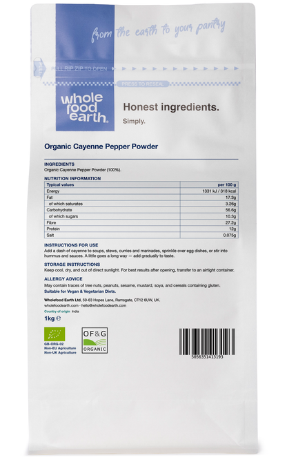 Organic cayenne pepper powder in a jar, part of herbs and spices from Whole Food Earth, with a textured spice background.