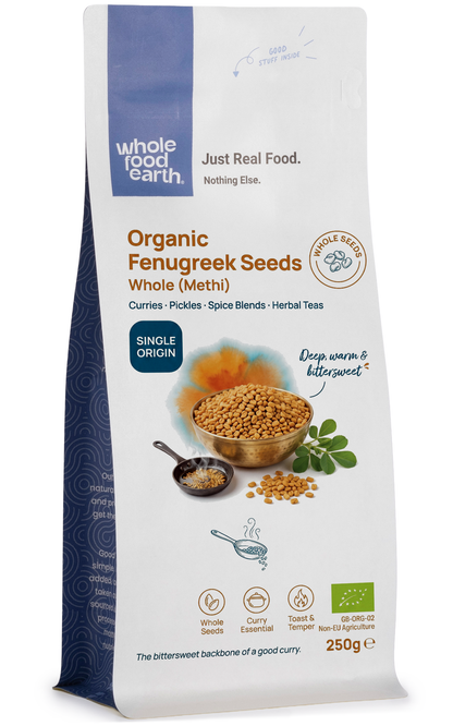 Whole organic fenugreek seeds from Whole Food Earth, showing small, golden-brown spice seeds in a clear container.