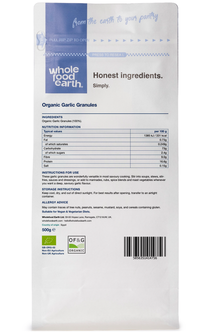 Back view of Whole Food Earth organic garlic granules in a clear jar, showcasing the herbal spice product.