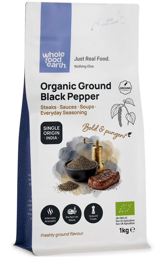 Organic ground black pepper from Whole Food Earth, a fine spice in a clear jar, showing the dark, ground pepper texture.
