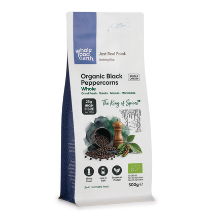 Whole Food Earth organic black peppercorns, whole herbs and spices in a clear jar, showcasing dark, round peppercorns ready for grinding.