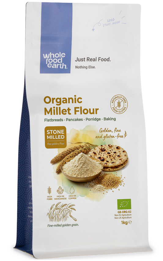 Organic millet flour in a clear bag, showing the light yellow, fine-textured grain product from Whole Food Earth.
