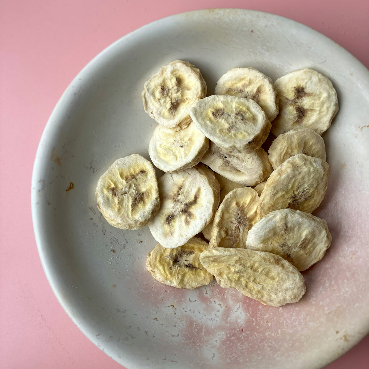 Sliced freeze-dried banana slices from Whole Food Earth, a healthy dried fruit snack with vibrant yellow color and crunchy texture.
