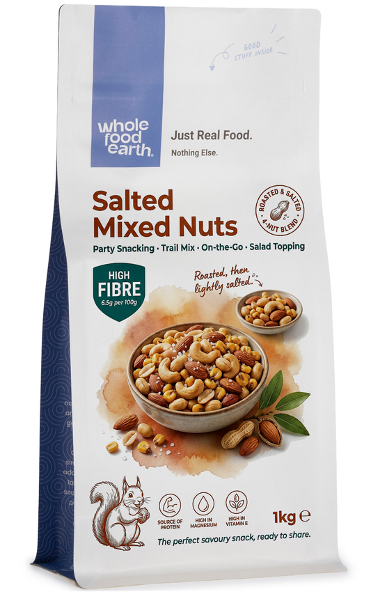 Mixed salted nuts from Whole Food Earth, including almonds, cashews, and walnuts, in a clear bowl on a white background.
