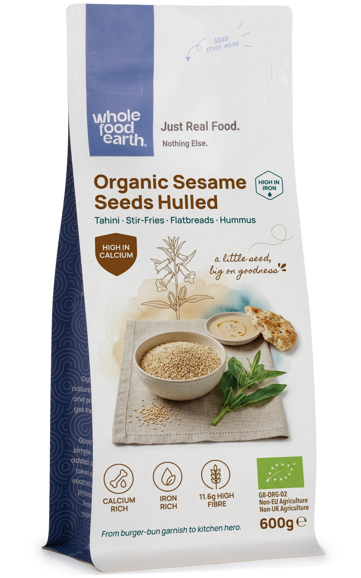 Organic sesame seeds hulled from Whole Food Earth, close-up of light tan, smooth, and shiny seeds in a clear container.