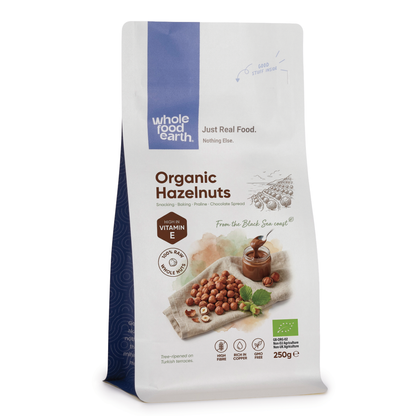 Whole Food Earth organic hazelnuts in a bowl, showcasing their brown shells and rich texture as a healthy nuts and seeds product.