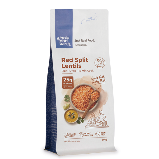 Organic red split lentils from ArtisanBox, displayed in a clear bowl showing vibrant orange-red lentils ready for cooking.