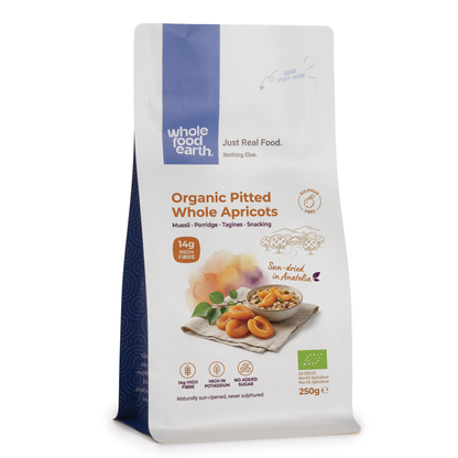Organic pitted whole apricots dried fruit from Whole Food Earth, showing plump, golden-brown dried apricots on a white background.