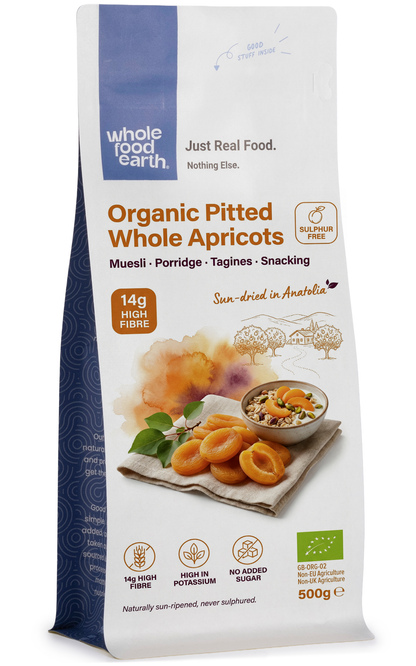 Organic pitted whole apricots from Whole Food Earth, dried fruit with vibrant orange color and smooth texture.