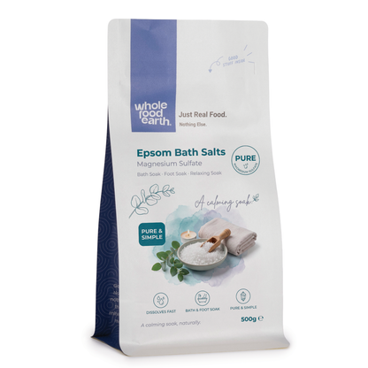 Epsom bath salts from Whole Food Earth, mineral and salt blend for relaxation, shown in a clear glass jar with a scoop.