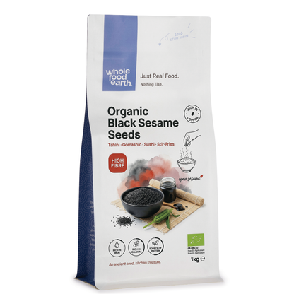 Organic black sesame seeds from Whole Food Earth, close-up of small, black seeds in a transparent container.