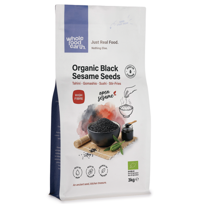Organic black sesame seeds from Whole Food Earth, close-up of small, shiny black seeds in a clear container.
