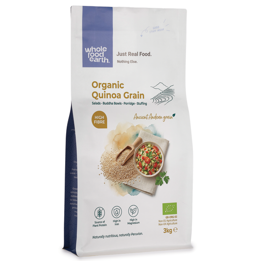 Organic quinoa grain from ArtisanBox displayed in a clear bowl, showing small, light-colored seeds with a natural, textured appearance.