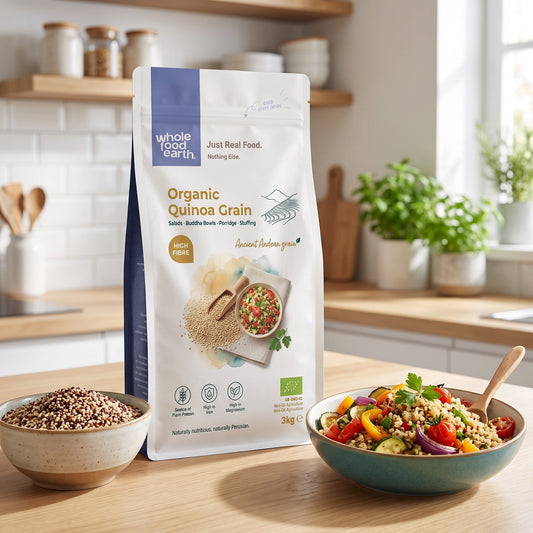Organic quinoa grain from ArtisanBox, showing a close-up of light tan, fluffy quinoa kernels in a natural setting.