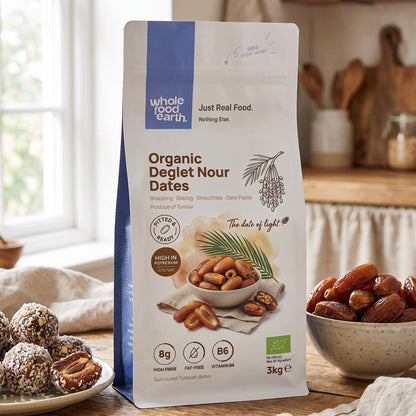 Organic Deglet Nour pitted dates from Whole Food Earth, a close-up of dried, glossy, sweet date fruits on a white background.