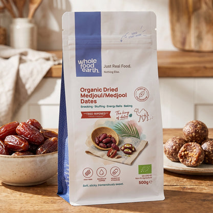 Organic dried Medjoul Medjool dates from Whole Food Earth, showcasing plump, glossy dried fruits in a natural setting.