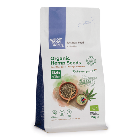 Organic hemp seeds from ArtisanBox displayed in a clear bowl, showcasing small, green, nutty seeds on a neutral background.