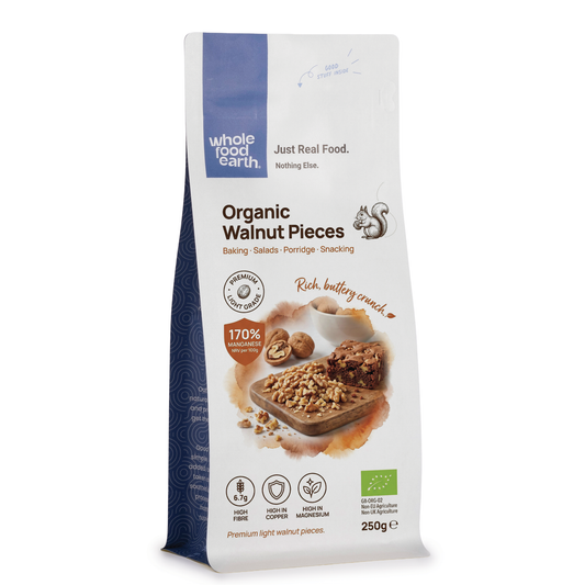Organic light walnut pieces from Whole Food Earth, showing raw, chopped walnuts in a natural, light color suitable for snacking or baking.