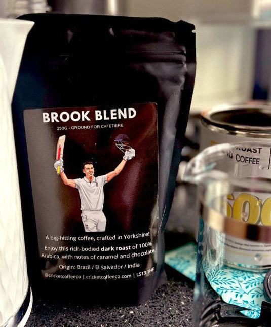 Dark roast coffee bag from Clubhouse Roastery's Brook Blend, featuring rich, aromatic coffee beans in a resealable bag.