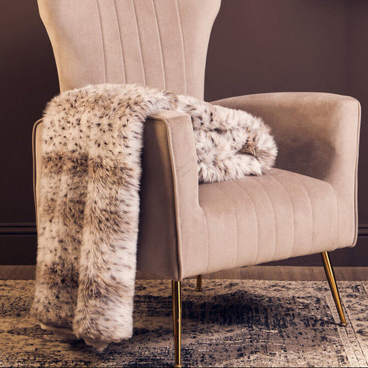 Orsina Bosie animal print fur throw, Lamina design, displayed on a sofa