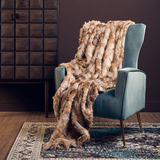 Orsina Bosie grey and natural fur throw displayed on a sofa
