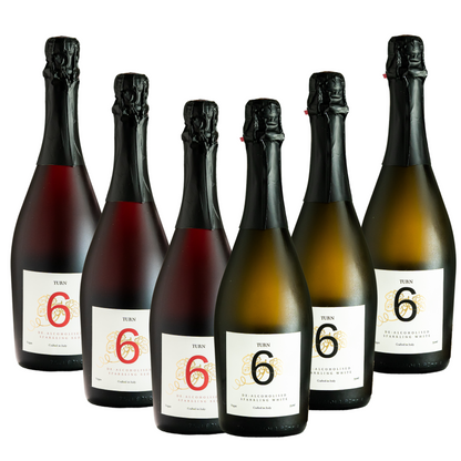 Six bottles of Turn 6 premium alcohol-free sparkling white and red wine in a case, showcasing colorful wine bottles against a neutral background.