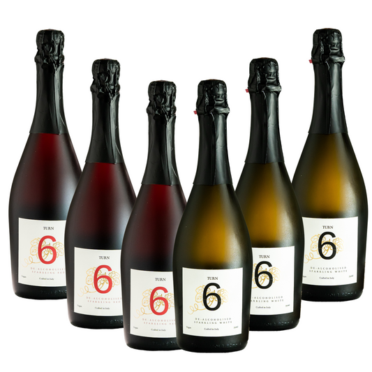 Six bottles of Turn 6 premium alcohol-free sparkling white and red wine in a case, showcasing colorful wine bottles against a neutral background.