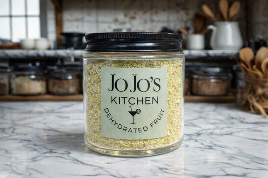 JoJo’s Kitchen lemon powder in a container, close-up of yellow lemon-flavored powdered spice for cooking and baking.