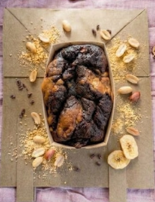 Vegan peanut butter, banana, and chocolate blondie from The Healthy Cake Company showing a moist, layered dessert bar with chocolate drizzle