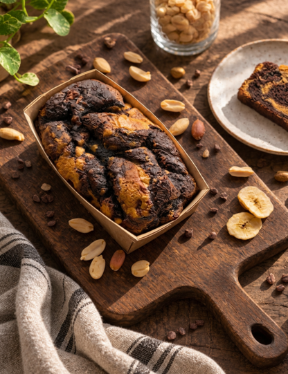 Vegan peanut butter, banana, and chocolate blondie from The Healthy Cake Company on a white plate with a fork.