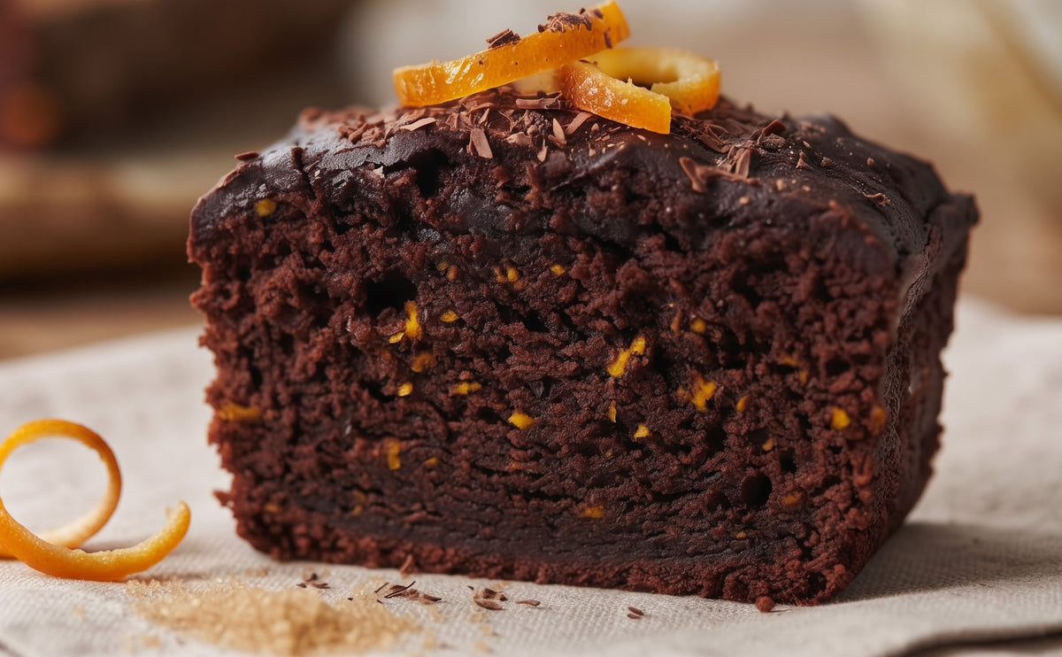Vegan Chocolate Orange Free From Cake by The Healthy Cake Company, sliced to show orange-flavored chocolate cake inside.