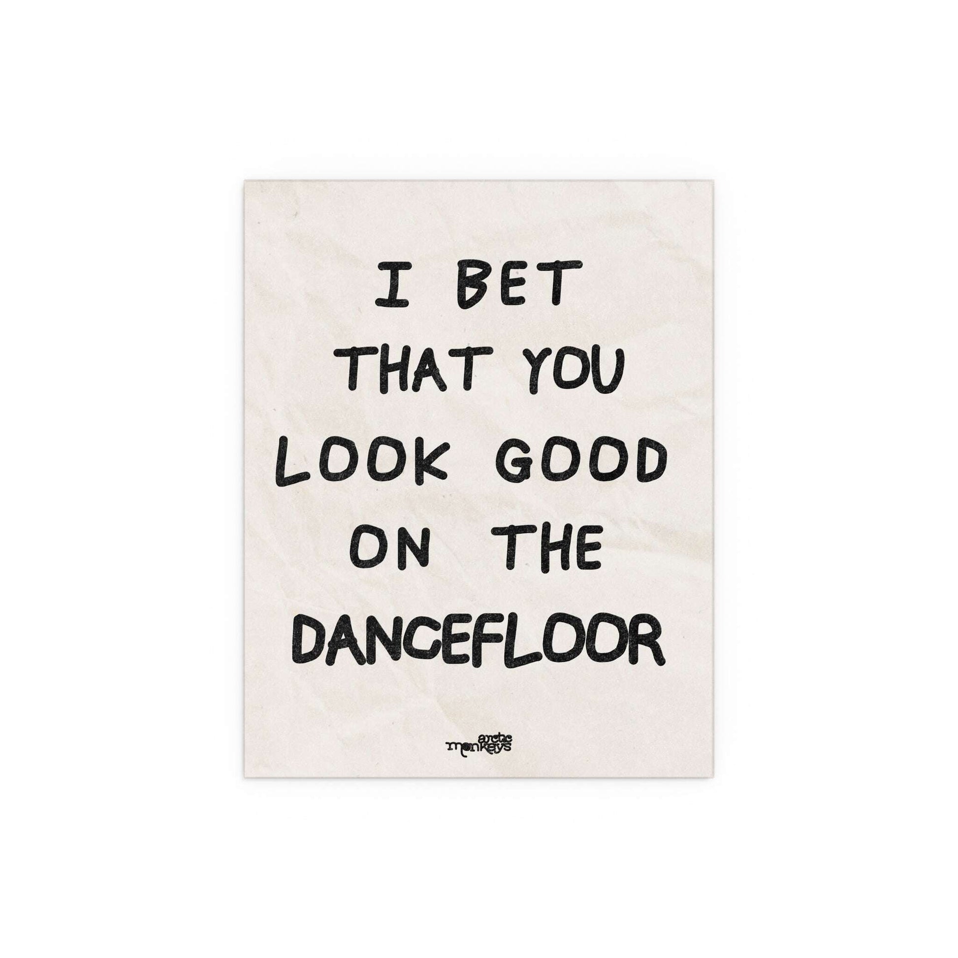 Arctic Monkeys poster featuring artwork for "I Bet You Look Good on the Dancefloor" by Glow On Prints, displayed on a wall.
