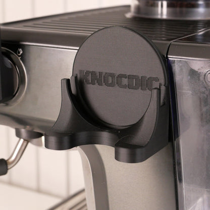 Magnetic universal portafilter holder for 51mm, 54mm, and 58mm portafilters by KNOCDIC® showing the holder and portafilter in use