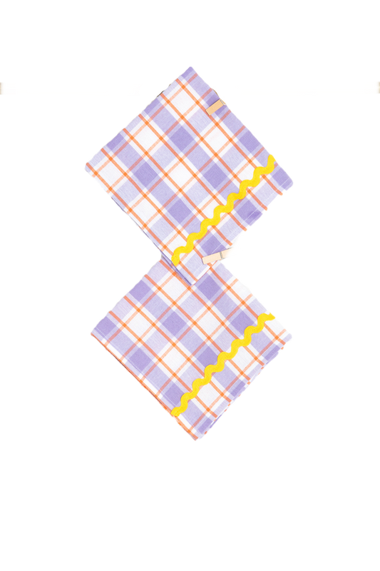 Set of two purple and yellow napkins by domenicamarland, featuring vibrant fabric with decorative patterns.