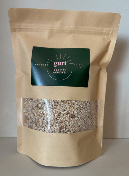 Gurt Lush Food Co honey and vanilla granola in a bowl with visible clusters, honey drizzles, and vanilla beans on top.