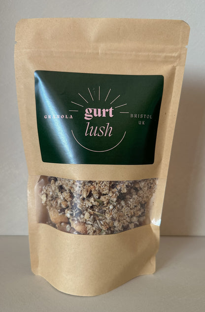 Dark chocolate, nut, and seed granola from Gurt Lush Food Co, with visible clusters of oats, nuts, seeds, and chocolate chunks.