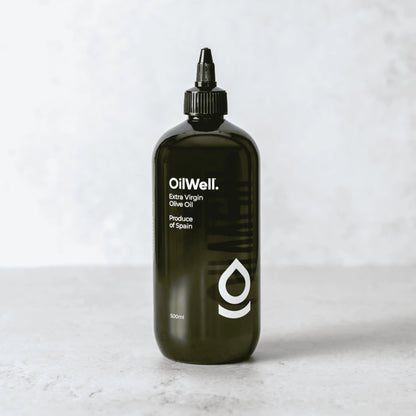 Light and smooth Spanish extra virgin olive oil from OilWell displayed in a clear glass bottle with a green cap.